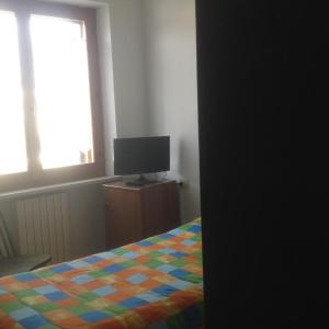 a bedroom with a bed and a television on a dresser at Il Sentiero in Ostra Vetere