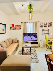 a living room with a couch and a tv at Awesome 2 bedrooms, living & dining area in General Trias