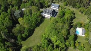 an aerial view of a large house in the forest at Manoir et Appartements avec piscine au Domaine de Bize Mirepoix in Mirepoix