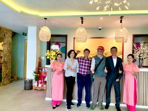 a group of people posing for a picture in a room at Aman Boutique Hotel in Hoi An