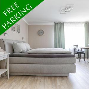 a bedroom with a bed with a green banner at S.F.C. Apartments in Trier