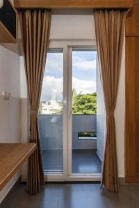 a sliding glass door with a view of a balcony at Home Awaits 357 in Bengaluru +15 photos