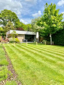a house with a large lawn in front of it at The Nook at Hillbrow in Romsey