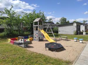 a playground with a slide and a play structure at La Maison Pritzwalk - Bett & Bike in Pritzwalk