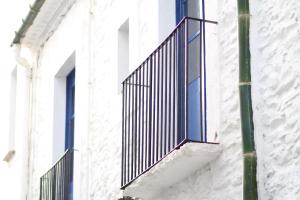 a window on the side of a building at Apartament - COMPARTIR in Cadaqués +4 photos