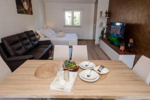 a living room with a table and a couch at Apartments Luka in Rab