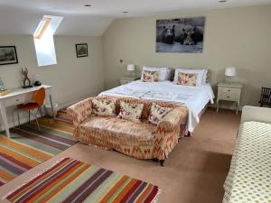 a bedroom with a bed and a couch at The Wickerman Granary in Kirkcudbright
