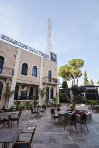 a building with tables and chairs in front of it at All Seasons Boutique Hotel - Jerusalem in Jerusalem