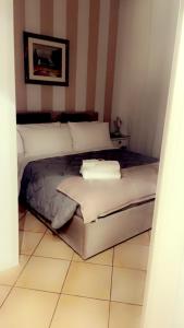 a bedroom with a bed with two pillows on it at All Suite Colosseo in Rome