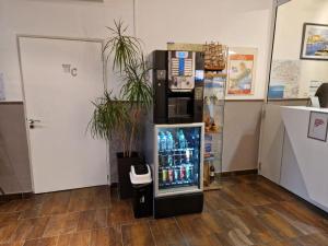 a vending machine in a room with a drink cooler at Le National in Sète