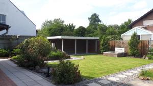 a garden with a pavilion in a backyard at Ferienhaus-Auszeitgeniessen in Heinsberg