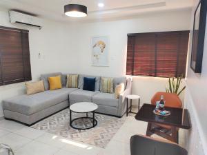 a living room with a couch and a table at The Leneade in Abuja