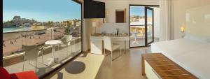 a hotel room with a bed and a view of a city at Hotel RH Portocristo & Wellness in Peñíscola