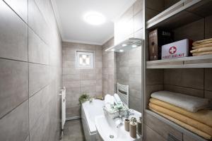 a small bathroom with a sink and a toilet at L&R Boutique Apartment in Oţelu Roşu +42 photos