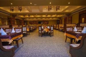 a dining room with tables and chairs in a room at Marugarh Resort and Spa in Jodhpur