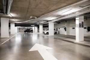 an empty parking garage with an arrow on the floor at Tribe Amsterdam City in Amsterdam
