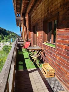 a table and chairs on the outside of a building at Grand appartement au pied des pistes ! in Chamrousse