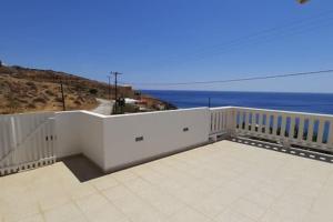 a white building with the ocean in the background at Marirena in Kali Limenes