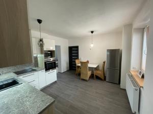 a kitchen and dining room with a table in it at Apartmán SUŠICE 