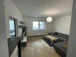 a living room with a couch and a tv at Apartmán SUŠICE 