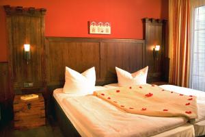 ビンツにあるBinzHotel Landhaus Waechterの赤い壁のベッドルーム1室(ベッド2台付)