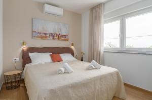 a bedroom with a bed with two towels on it at Villa Bella N in Višnjan +48 photos