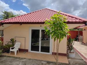 a small house with a white chair in front of it at Trang Villa Hotel and Water Park in Trang