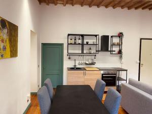 a kitchen with a table and chairs in a room at Portrait of Livorno in Livorno