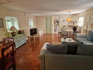 a living room with a couch and a tv and a kitchen at Casa Rural Luna in Candeleda +36 photos