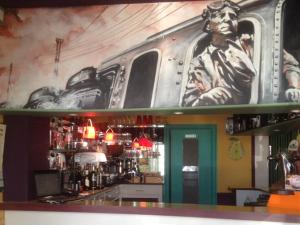 a bar with a train mural on the wall at Hotel Moderne in Vire