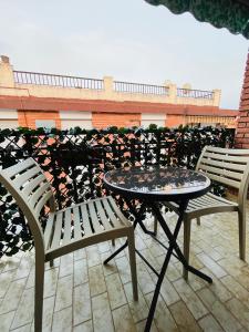 two chairs and a table on a patio at Apartamento El Arenal - Free Parking in Córdoba