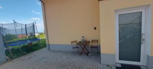 a patio with a table and a sliding glass door at Traumblick Südpfalz in Burrweiler +2 photos