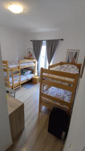 a room with two bunk beds and a window at San Eleuterio Guesthouse in Poreč