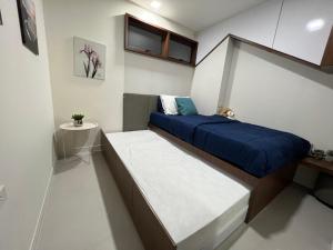 Voodi või voodid majutusasutuse Hi Sea E272 At Escape Condominium Mae Pim Beach toas
