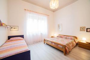 a bedroom with two beds and a window at Giglio di Mare, Darsena Viareggio in Viareggio