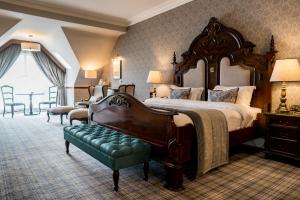 a large bedroom with a large bed and a green bench at Harvey's Point in Donegal