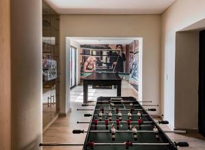 a room with a pool table in the middle of it at Villa Legacy in Cape Town