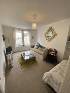 a living room with a couch and a table at Apartment in Old Town near the beach in Hastings