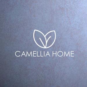 a white logo on a blue background at C A M E L L I A - H O M E in Cipolletti