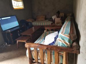 a woman sitting in a room with two bunk beds at Sunrise homestay Sipi in Kapchorwa