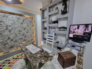 a living room with a couch and a television at Spring house in Qaryat Shākūsh +24 photos