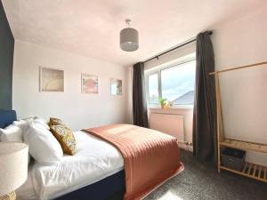 a bedroom with a bed and a large window at uSnooz - New for 2023! Cosy house, 2 bed in Hipperholme