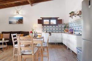 a kitchen and living room with a table and chairs at El Algarrobero in Santa Lucía