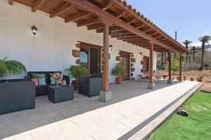 an outdoor patio with couches and a pavilion at El Algarrobero in Santa Lucía