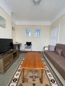 a living room with a couch and a coffee table at Stunning 1 Bedroom Home in Southend-on-Sea