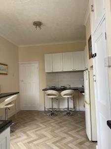 a kitchen with a counter and stools in a room at Stunning 1 Bedroom Home in Southend-on-Sea