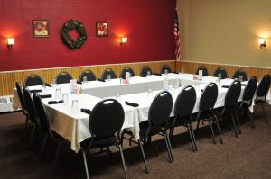 a large white table in a room with chairs at Yellowstone River Inn in Glendive
