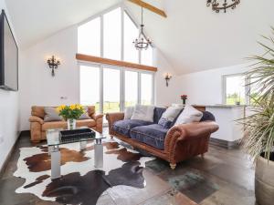 a living room with a couch and a table at Polly's Annexe in Ipswich