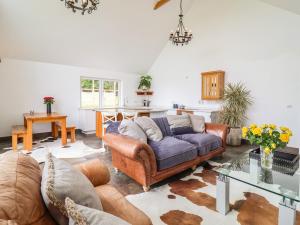 a living room with a couch and a table at Polly's Annexe in Ipswich