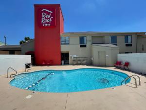 a pool in front of a red roof inn at Red Roof Inn Branson in Branson